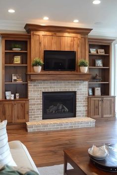 a living room filled with furniture and a flat screen tv mounted above a fire place