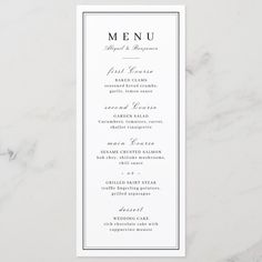 a white menu card with black lettering on the front and bottom, in an elegant frame