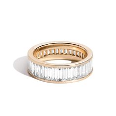 This Shahla baguette-cut lab-created diamond band is inspired by the structural boldness of the iconic Rockefeller Center. 14K gold 1/8 ct. channel-set baguette-cut lab-created diamonds completely encircle the band 5-5/8 cts. t.w. of lab-created diamonds Fits true to size Each item is custom made and not eligible for returns Luxury Jewelry With Vvs Clarity Baguette, Luxury Baguette Jewelry With Vvs Clarity, Luxury Channel Set Baguette Cut Jewelry, Baguette Eternity Ring, Baguette Eternity Band, Baguette Band, Baguette Wedding Band, Iconic New York, Chanel Set