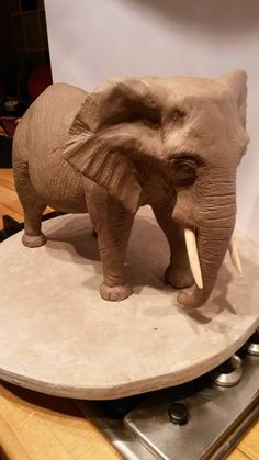 an elephant statue sitting on top of a table