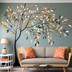 a living room with a tree painted on the wall next to a couch and coffee table