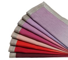 a stack of different colored napkins sitting on top of each other