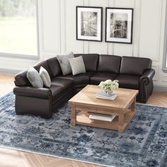 a living room with a sectional couch and coffee table