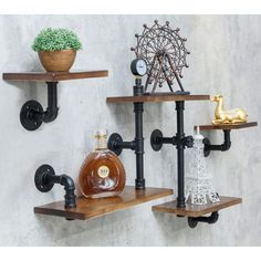 two wooden shelves with black pipe pipes and bottles on them, one shelf is holding a bottle