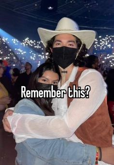 a man in a cowboy hat hugging a woman wearing a face mask