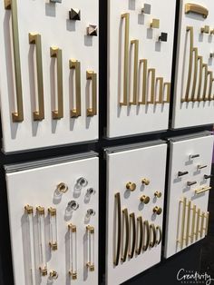 four white drawers with gold handles and knobs on each drawer, all lined up against the wall