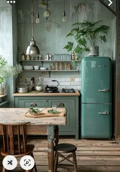 an old fashioned kitchen with green cabinets and wooden floors