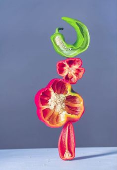 three peppers are stacked on top of each other to form the shape of a flower