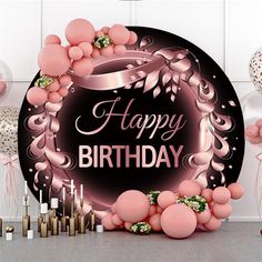 a happy birthday sign surrounded by balloons and confetti on a table with candles