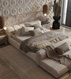 a large bed sitting on top of a wooden floor next to a wall covered in circles