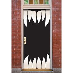 an image of a door decorated to look like a monster's mouth with sharp teeth