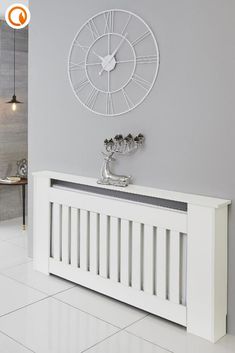 a white radiator with a clock on the wall