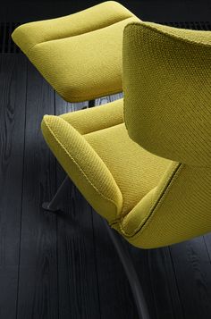 a yellow chair sitting on top of a wooden floor