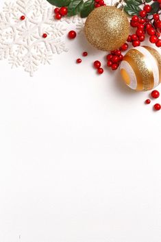 christmas decorations on white background with snowflakes and red berries in the foreground