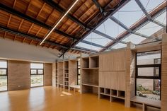 an empty room with wooden shelves and windows