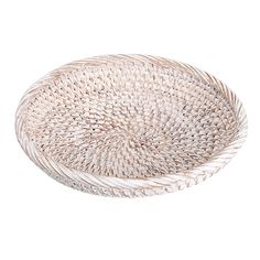 a white woven bowl sitting on top of a table