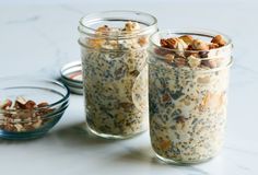 three jars filled with food sitting on top of a table