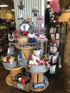 a display in a store filled with lots of stuffed animals and other items on wooden shelves