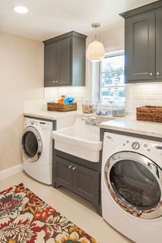 a washer and dryer sitting in a room next to each other on a rug