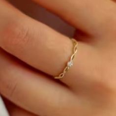 a woman's hand with a gold ring on it