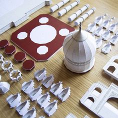 paper cutouts are laid out on the table to be made into architectural models and decorations