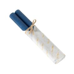 two blue candles wrapped in white paper and tied with twine on top of each other