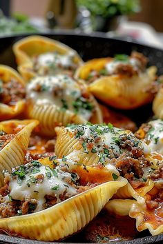 several stuffed shells with meat and cheese in a skillet