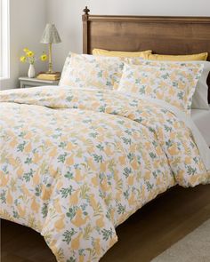 a yellow and white bed with pineapples on it