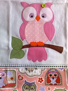 a pink owl sitting on top of a tree branch