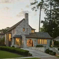 a stone house with steps leading up to the front door and windows on each side