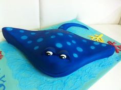 a blue cake decorated with an octopus and starfish