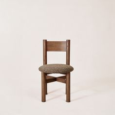 a wooden chair with a seat cushion on it