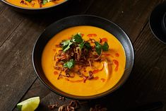 two bowls filled with soup and garnished with cilantro