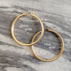 * ZOOM for better detail * Water safe The classic hoop earrings, they'll never go out of style. These hoops measure 2mm in width! ♥️ Sold individually or as a bundle. FEATURES: - 14k Gold Filled MEASUREMENTS: - Hoops measure (from smallest to largest): .75 inch, .90 inch, and 1.2 inch. Medium Hoop Earrings, Real Gold Jewelry, Big Hoop Earrings, Gold Filled Hoops, Jewelry Cleaner, Gold Chain Necklace, Dainty Jewelry, Go Out, Out Of Style