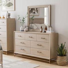 a bedroom scene with focus on the dresser and mirror