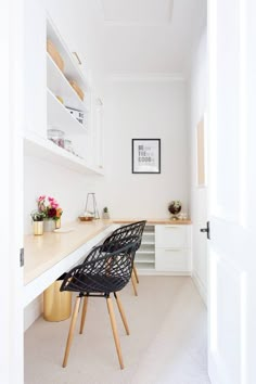 an instagram photo of a home office with white walls and wooden desks in the corner