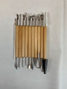 a bunch of tools are lined up on a table top with one tool in the middle