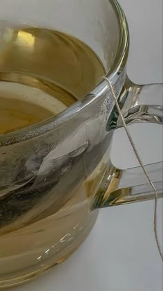 a glass cup filled with liquid sitting on top of a table