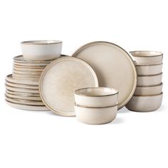 a stack of white dishes with gold rims