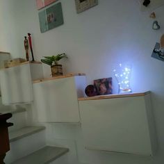 the stairs are decorated with lights and pictures on them, along with other items in vases