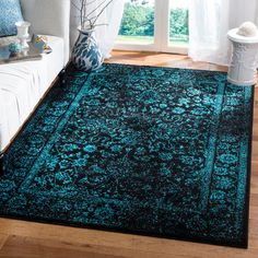 a living room with a blue rug on the floor