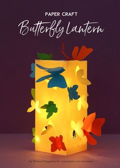 a paper lantern with colorful butterflies on it and the words butterfly lantern written in white