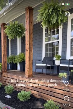 the front porch is decorated with potted plants