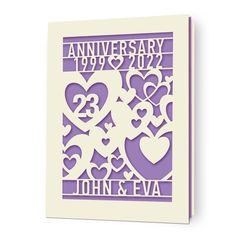 an anniversary card with hearts cut out from the front and back of it, on a white background