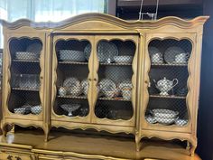 an antique china cabinet with glass doors