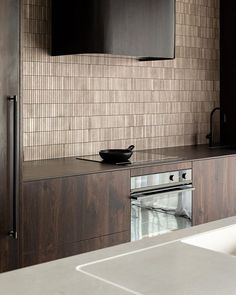 a kitchen counter with a bowl on top of it next to a microwave and oven