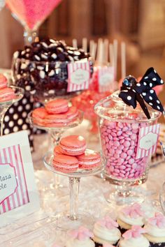 a table topped with lots of cupcakes and candy