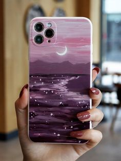 a woman holding up her phone case with the painting on it