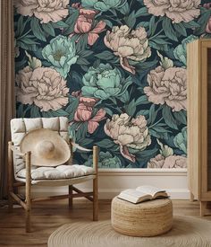 a room with a chair, rug and wallpaper that has flowers painted on it