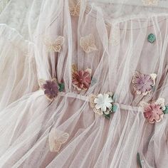 there are many flowers on the sheer fabric